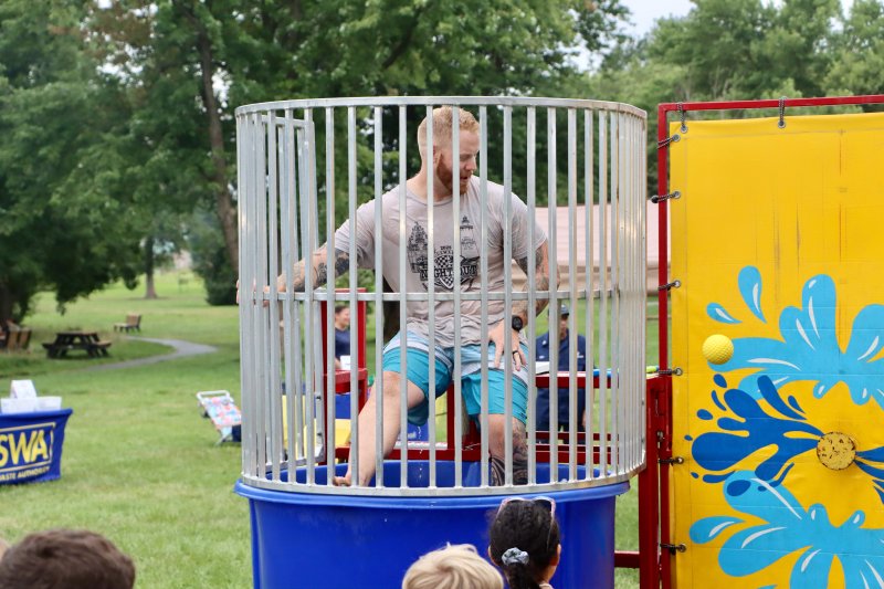 Lewes police officer Nick Yatsko, already drenched in the dunk tank, looks on with anticipation as another ball heads for the plunger.